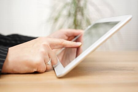 Woman is  working on tablet computerの写真素材