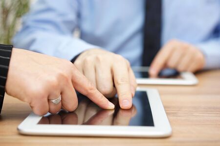 businessman is explaining report on tablet computerの写真素材