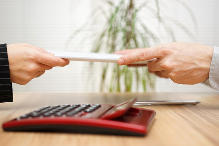 Businesswoman gives  documentation to his clientの写真素材