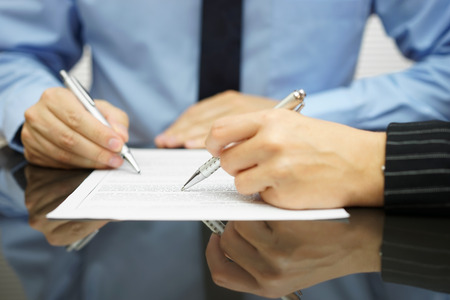 business team in meeting is working together on financial or legal document