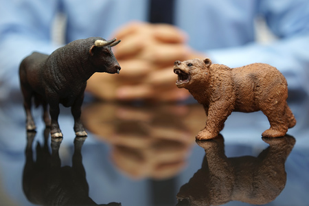 businessman is watching bull and bear , concept of stock market and investingの写真素材