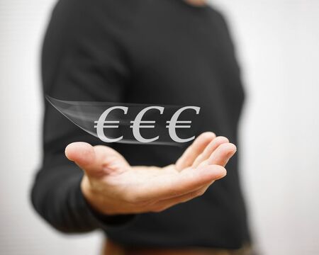 man catches virtual euro money, concept of currency and moneyの写真素材