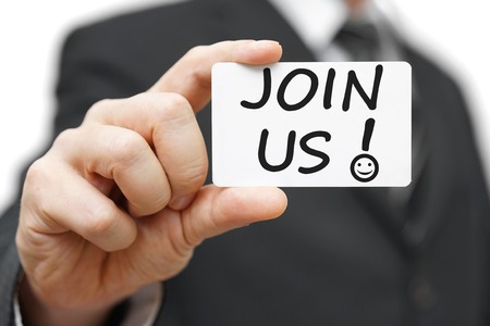 Businessman holding contact card with the Join Us and exclamation mark with smile iconの写真素材