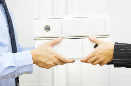 Manager in public administration gives work to employeeの写真素材