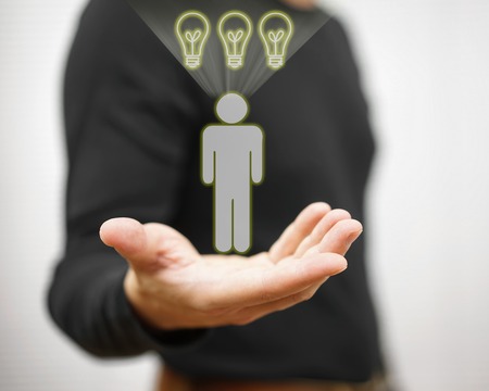 Man is showing virtual person with light bulbs above his head. Concept of employee with full of ideasの写真素材