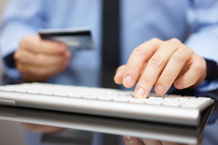 businessman in office is making bank transfer or on line purchase with credit cardの写真素材