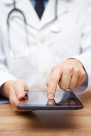 doctor is working on tablet computerの写真素材