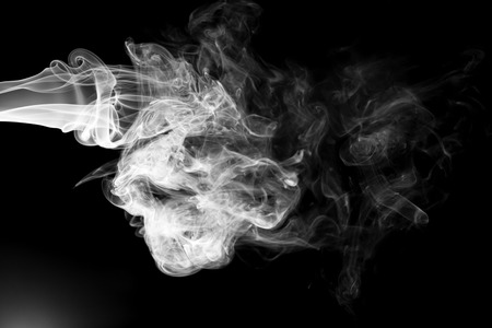 White smoke isolated on black backgroundの写真素材