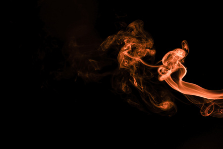 Brown coloured smoke abstract lighting on a black backgroundの写真素材
