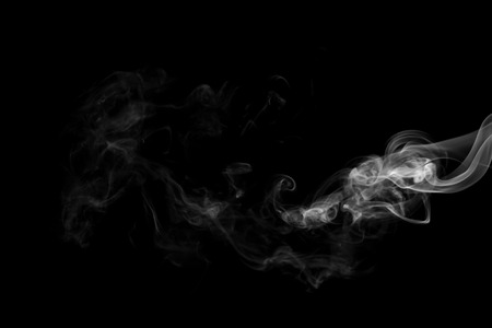 White smoke isolated on black backgroundの写真素材