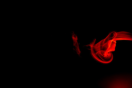 Red smoke abstract on black backgroundの写真素材