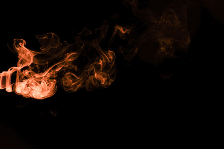 Brown coloured smoke abstract lighting on a black backgroundの写真素材