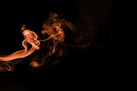 Brown coloured smoke abstract lighting on a black backgroundの写真素材