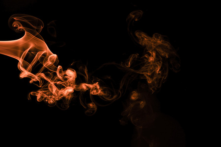 Brown coloured smoke abstract lighting on a black backgroundの写真素材