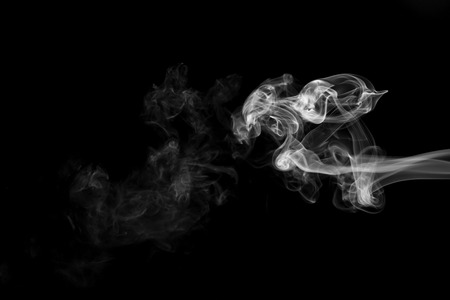 White smoke isolated on black backgroundの写真素材