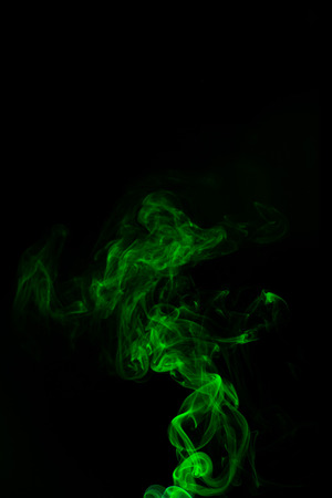 Green coloured smoke abstract lighting on a black backgroundの写真素材