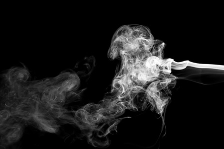White smoke isolated on black backgroundの写真素材