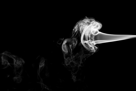White smoke isolated on black backgroundの写真素材