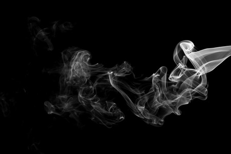 White smoke isolated on black backgroundの写真素材
