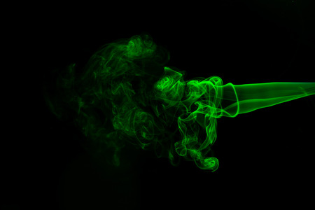 Green coloured smoke abstract lighting on a black backgroundの写真素材