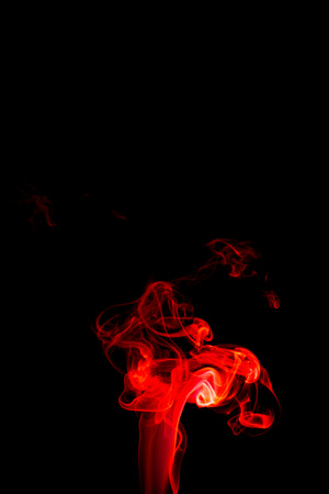 Red smoke abstract on black backgroundの写真素材