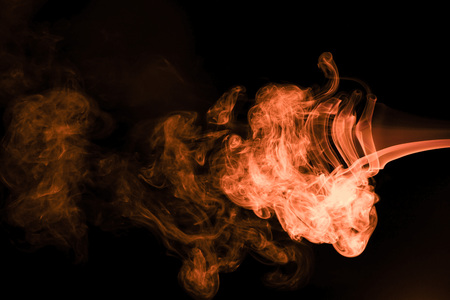 Brown coloured smoke abstract lighting on a black backgroundの写真素材