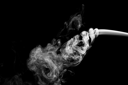 White smoke isolated on black backgroundの写真素材