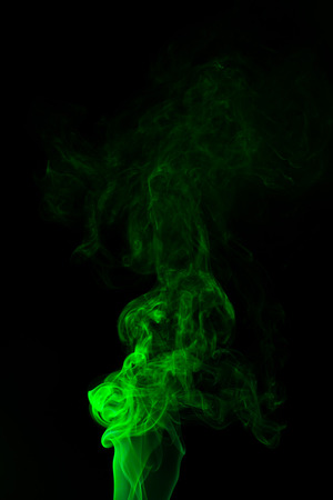 Green coloured smoke abstract lighting on a black backgroundの写真素材