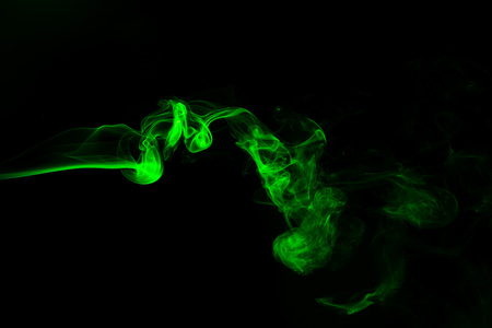Green coloured smoke abstract lighting on a black backgroundの写真素材