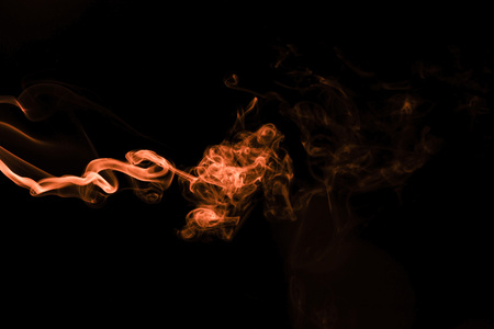 Brown coloured smoke abstract lighting on a black backgroundの写真素材