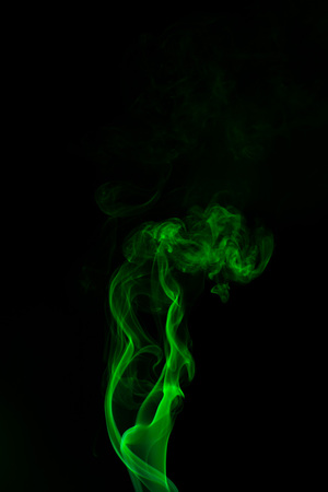 Green coloured smoke abstract lighting on a black backgroundの写真素材