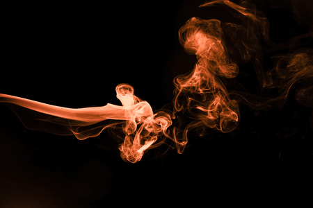 Brown coloured smoke abstract lighting on a black backgroundの写真素材