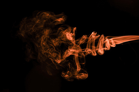 Brown coloured smoke abstract lighting on a black backgroundの写真素材