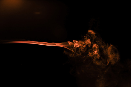 Brown coloured smoke abstract lighting on a black backgroundの写真素材