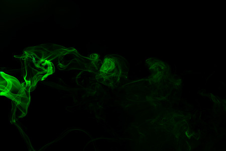 Green coloured smoke abstract lighting on a black backgroundの写真素材