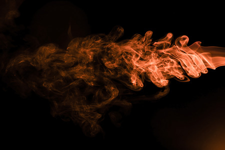 Brown coloured smoke abstract lighting on a black backgroundの写真素材