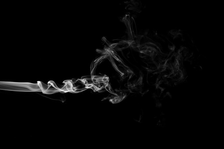 White smoke isolated on black backgroundの写真素材