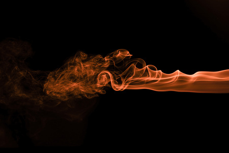 Brown coloured smoke abstract lighting on a black backgroundの写真素材