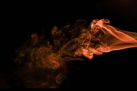 Brown coloured smoke abstract lighting on a black backgroundの写真素材
