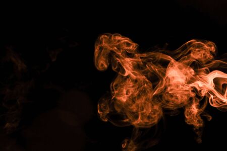 Brown coloured smoke abstract lighting on a black backgroundの写真素材