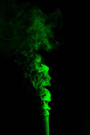 Green coloured smoke abstract lighting on a black backgroundの写真素材
