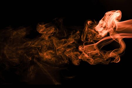 Brown coloured smoke abstract lighting on a black backgroundの写真素材