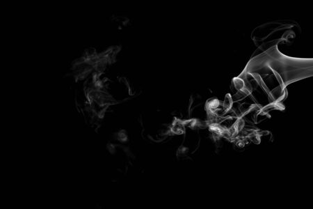 White smoke isolated on black backgroundの写真素材