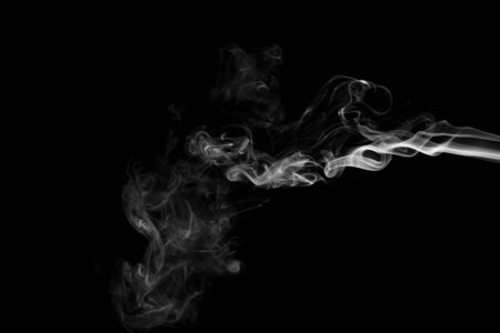 White smoke isolated on black backgroundの写真素材