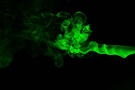 Green coloured smoke abstract lighting on a black backgroundの写真素材