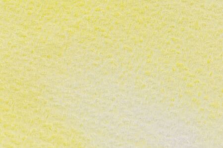 Abstract yellow watercolor painting textured on white paper backgroundの写真素材