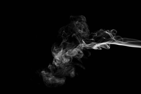 White smoke isolated on black backgroundの写真素材