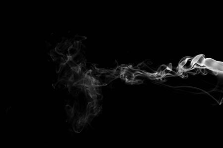White smoke isolated on black backgroundの写真素材