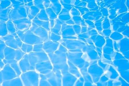 Ripple water in swimming pool sun reflectionの写真素材