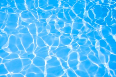 Ripple water in swimming pool sun reflectionの写真素材